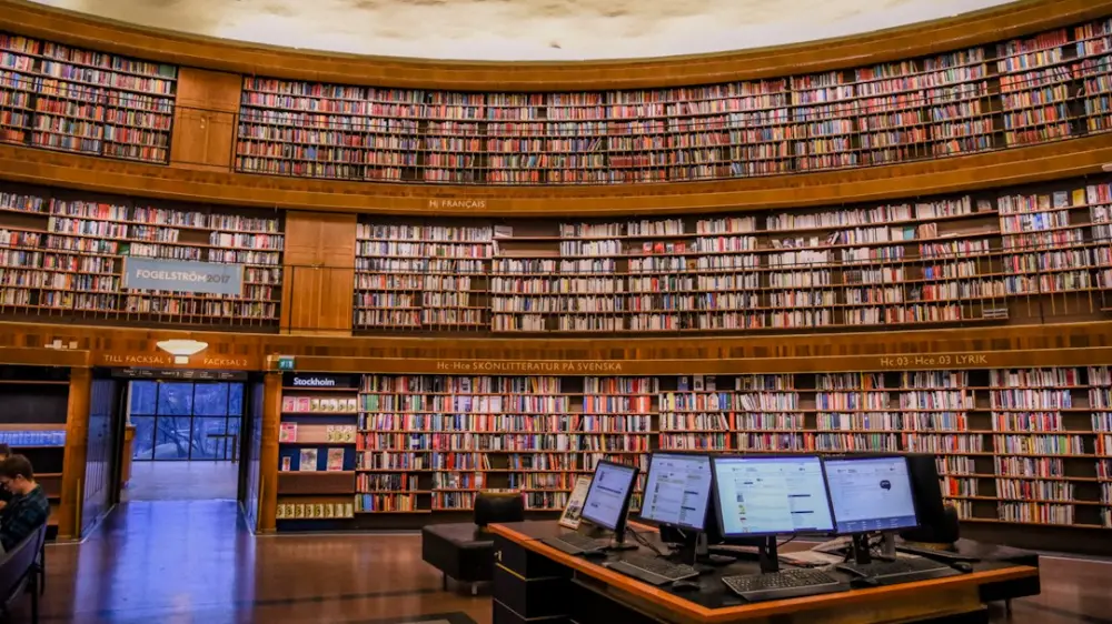 Brown wooden book shelves in library, illustrating libraries and digital knowledge archives